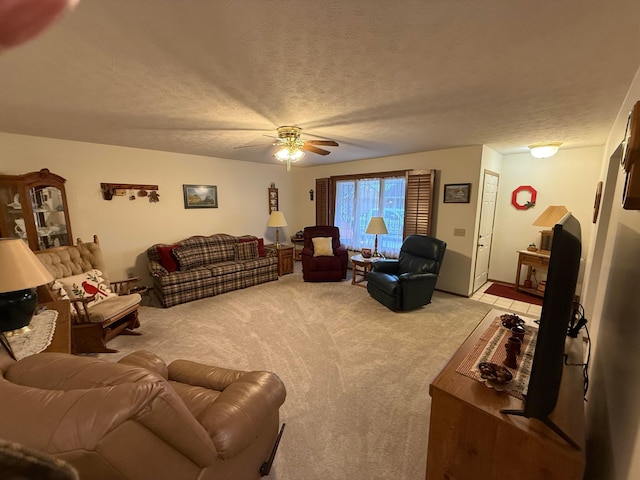 carpeted living room featuring ceiling fan and a textured ceiling