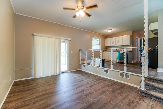 interior space featuring a textured ceiling, dark hardwood / wood-style flooring, ceiling fan, and crown molding