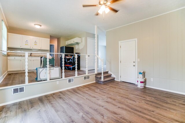 mudroom with light hardwood / wood-style floors, ceiling fan, and ornamental molding