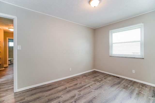 empty room with hardwood / wood-style floors