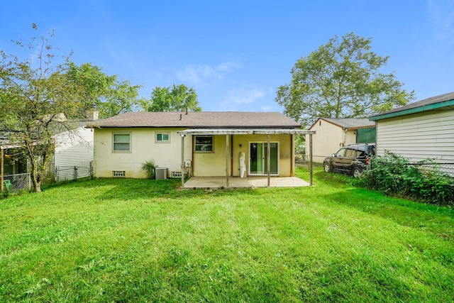 back of house featuring central AC, a yard, and a patio