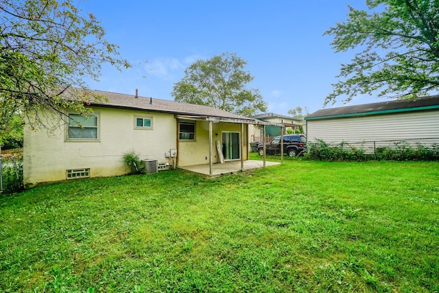 back of house featuring a lawn, a patio, and central AC unit