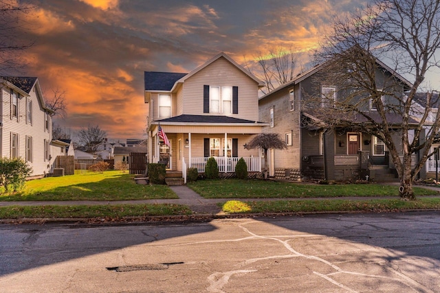 front facade with a lawn and a porch