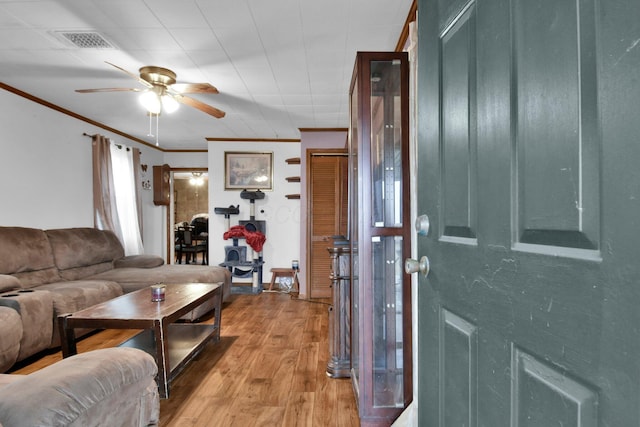 4417 Beechgrove Rd, Bucyrus, OH 44820 - living room with ceiling fan, crown molding, and light hardwood / wood-style floors