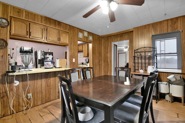 4417 Beechgrove Rd, Bucyrus, OH 44820 - dining space with light hardwood / wood-style floors and wooden walls
