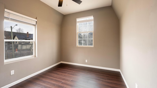 spare room featuring dark hardwood / wood-style flooring and ceiling fan