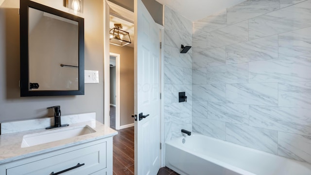 bathroom featuring vanity, tiled shower / bath, and hardwood / wood-style flooring