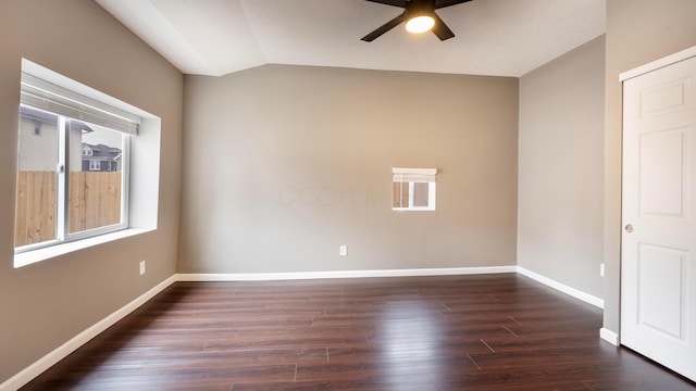 empty room with dark hardwood / wood-style flooring, ceiling fan, and lofted ceiling