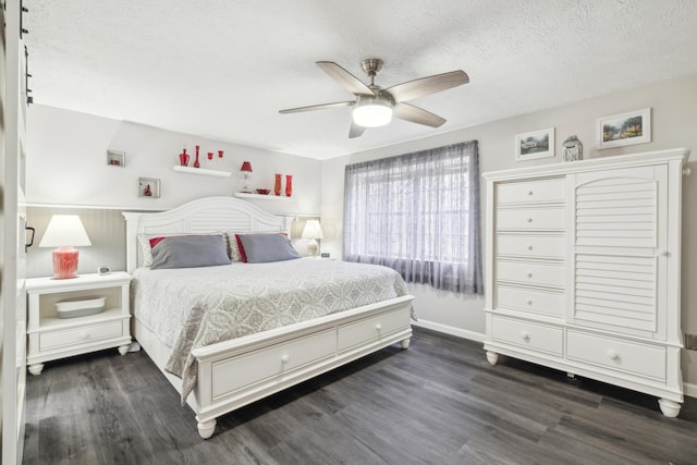 bedroom with a textured ceiling, dark hardwood / wood-style floors, and ceiling fan