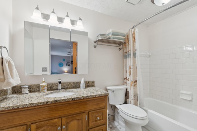 full bathroom featuring shower / bath combo with shower curtain, vanity, a textured ceiling, and toilet