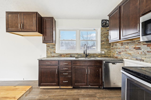 kitchen with backsplash, dark hardwood / wood-style flooring, sink, and stainless steel appliances