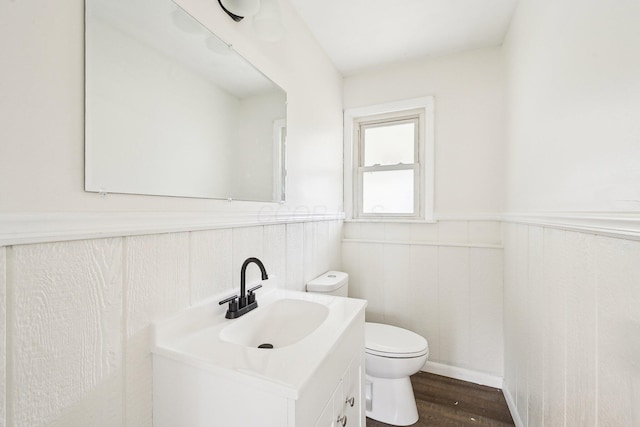 bathroom with vanity, wood-type flooring, and toilet