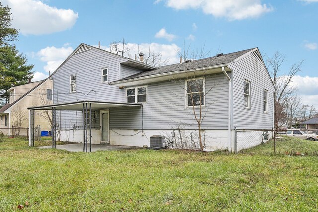 back of property featuring a lawn, a patio, and central AC