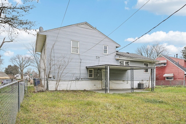 rear view of house featuring a yard, a patio, and central AC