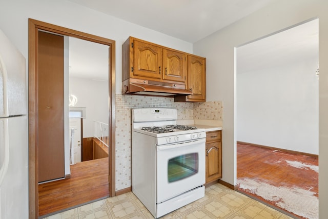 kitchen with backsplash and white appliances