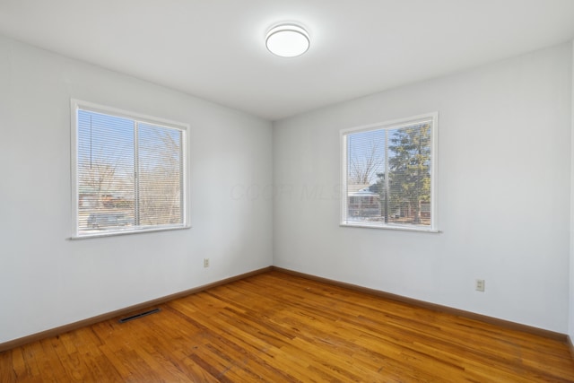 unfurnished room with wood-type flooring