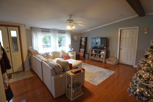 living room featuring ceiling fan, hardwood / wood-style floors, lofted ceiling with beams, and ornamental molding