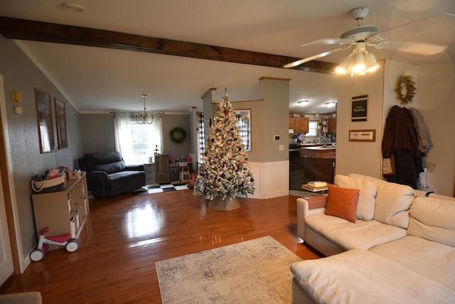 living room featuring wood-type flooring, ceiling fan, and beam ceiling