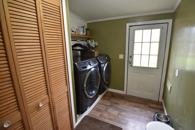 laundry room featuring ornamental molding, dark wood-type flooring, and independent washer and dryer