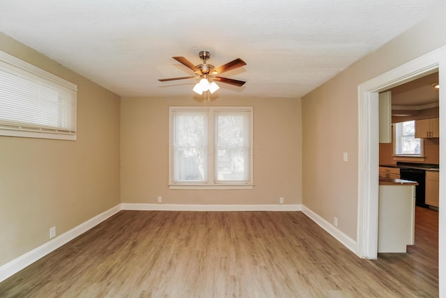 spare room featuring ceiling fan and light hardwood / wood-style floors