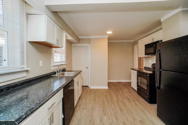 kitchen featuring white cabinetry, sink, crown molding, light hardwood / wood-style floors, and black appliances