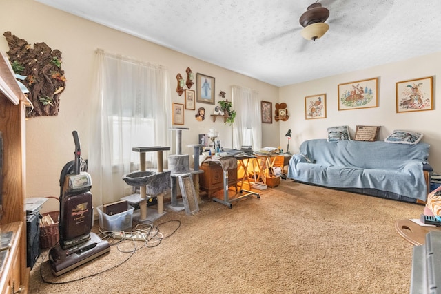 bedroom with carpet, ceiling fan, and a textured ceiling