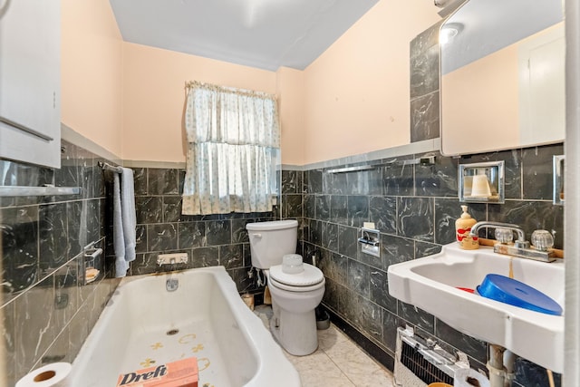 bathroom featuring tile patterned floors, sink, tile walls, and toilet