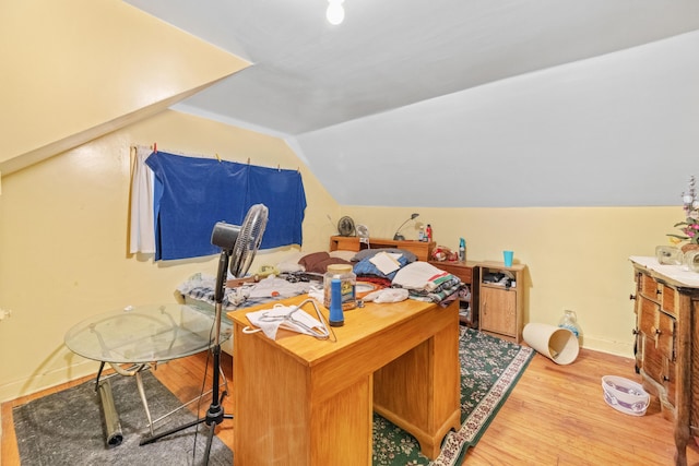 office space featuring lofted ceiling and light hardwood / wood-style flooring