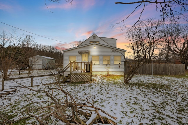 view of snow covered back of property