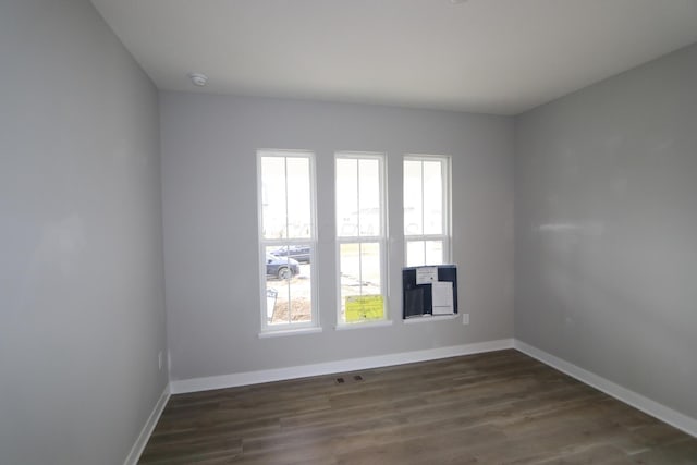 empty room with dark hardwood / wood-style floors