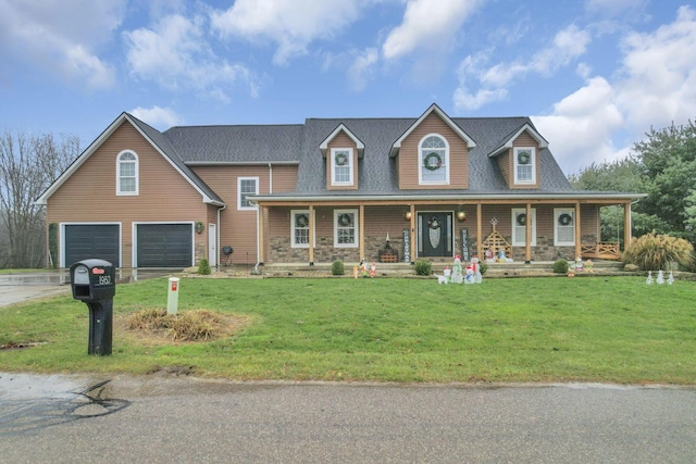 view of front of property featuring a porch, a garage, and a front lawn