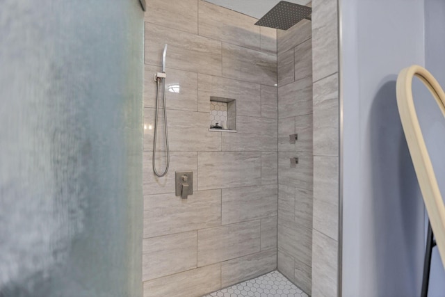 bathroom with a tile shower