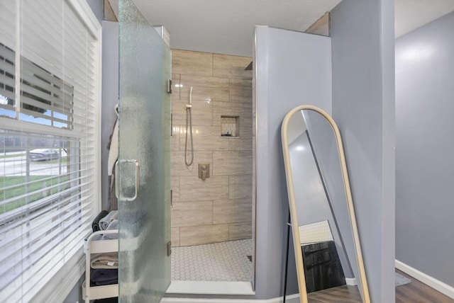 bathroom with wood-type flooring and a shower with door