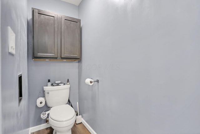 bathroom with toilet and hardwood / wood-style floors