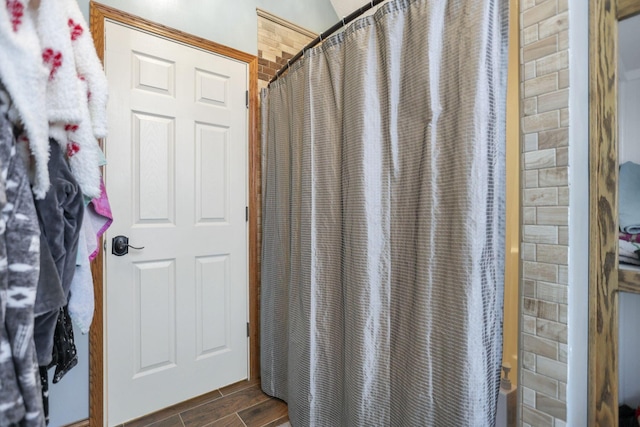 bathroom featuring hardwood / wood-style floors and curtained shower