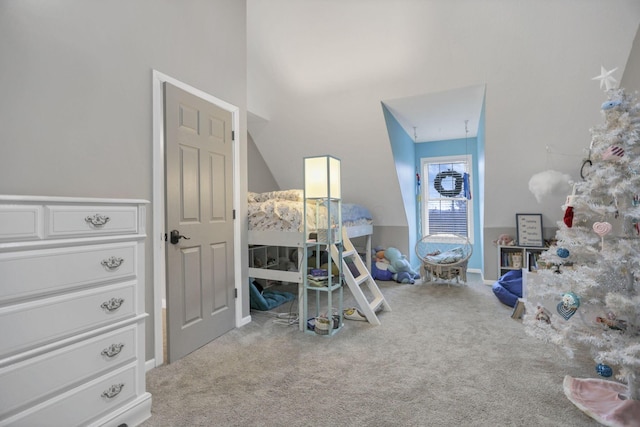 bedroom with carpet floors and vaulted ceiling