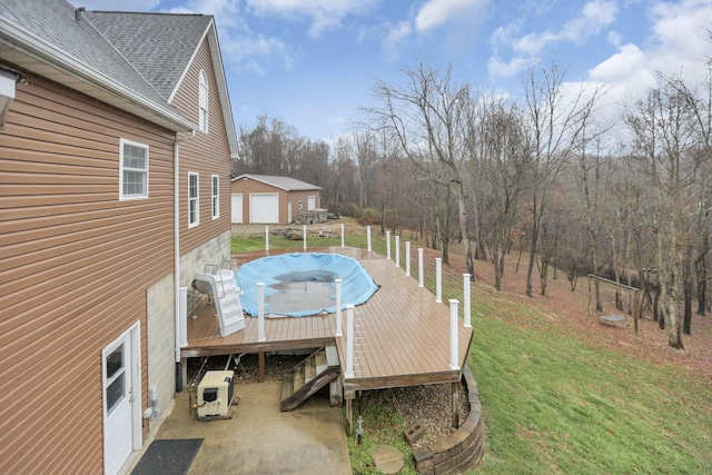 wooden terrace featuring ac unit and a yard