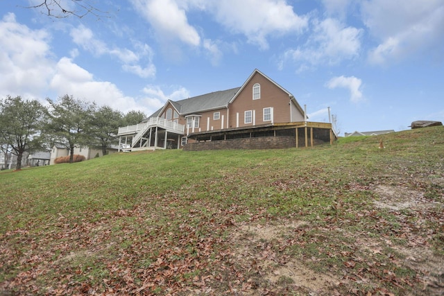 back of house with a lawn and a wooden deck