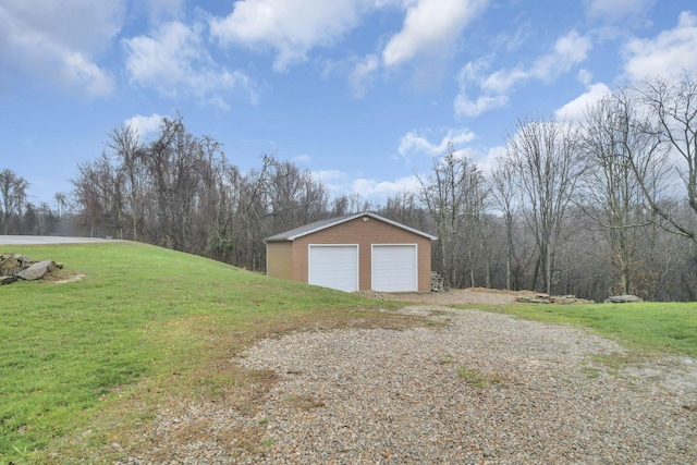 garage featuring a lawn