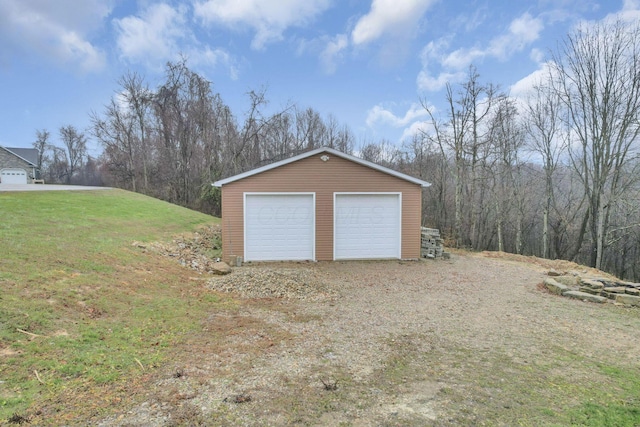 garage featuring a lawn