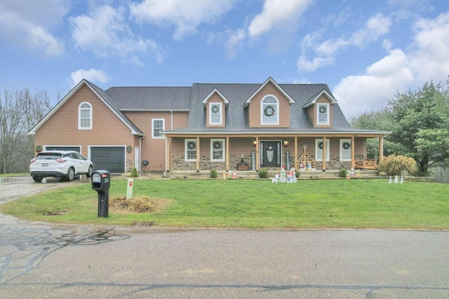 view of front of house with a porch, a garage, and a front yard