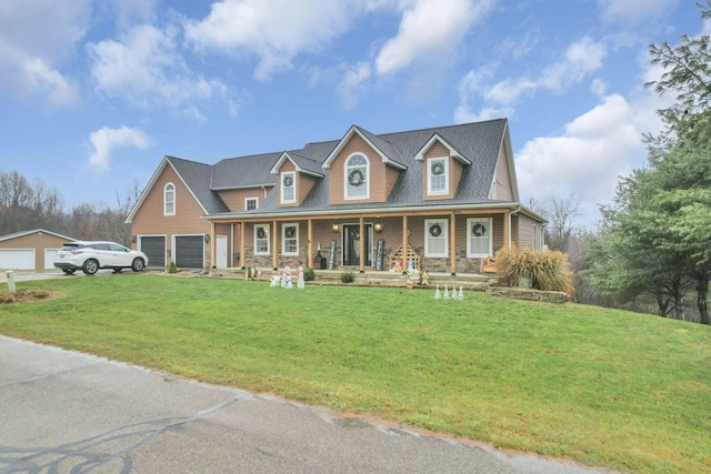 cape cod-style house with covered porch, a garage, and a front lawn