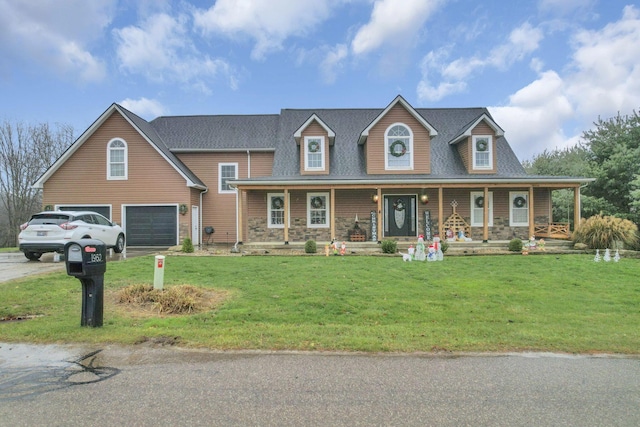 view of front of property featuring a garage, covered porch, and a front lawn