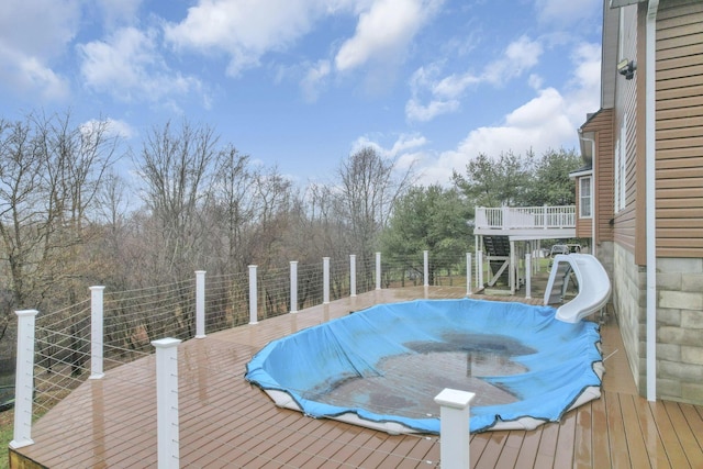 view of swimming pool featuring a wooden deck