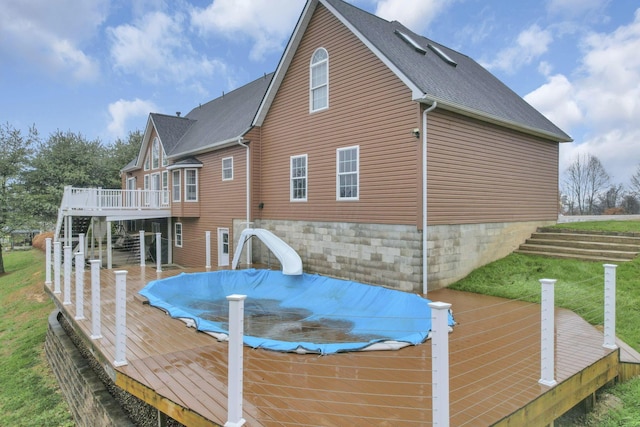 rear view of property with a yard and a deck