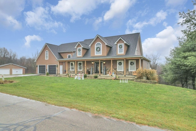 cape cod home with an outbuilding, covered porch, a front yard, and a garage