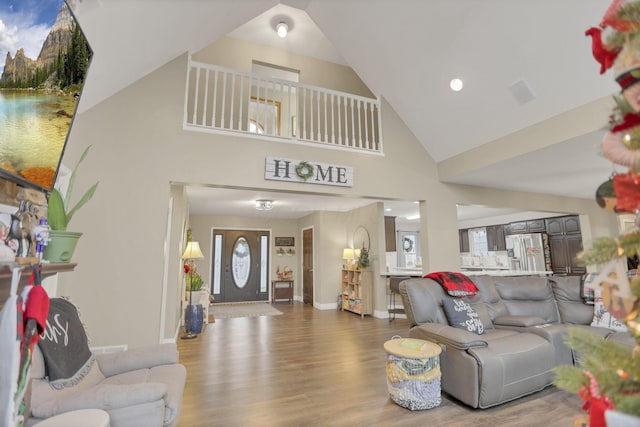 living room featuring high vaulted ceiling and hardwood / wood-style floors