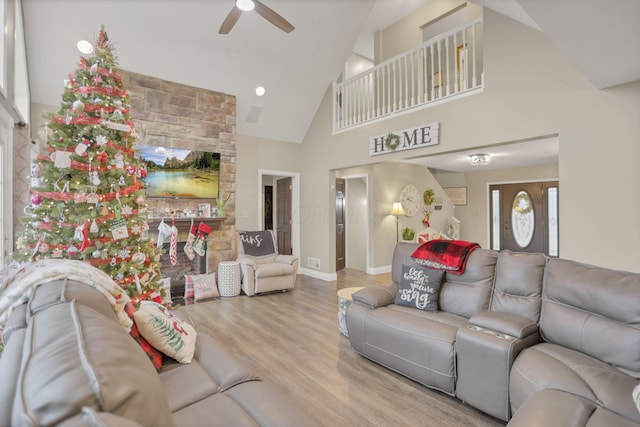 living room featuring hardwood / wood-style floors, high vaulted ceiling, and ceiling fan