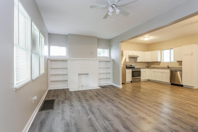 kitchen with ceiling fan, light wood-type flooring, white cabinetry, and stainless steel appliances