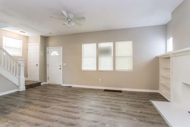 foyer featuring ceiling fan and dark wood-type flooring